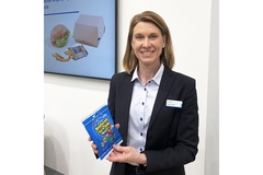 A woman from Walki showing Walki's candy packaging made from paper.